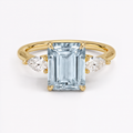 Anillo de compromiso tres piedras, forma corte esmeralda, con aguamarina, en oro amarillo, Joyería Bruzzone